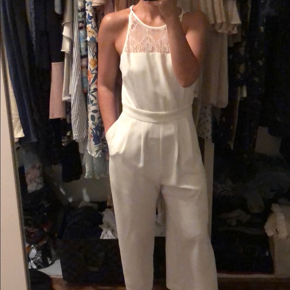 White coulette jumpsuit. Beautiful lace detail.